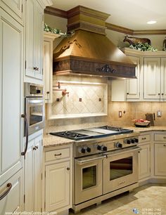 a kitchen with an oven, range and cabinets in it's center island area