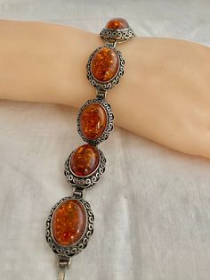 "Poland Amber Cabochons Filagree Vintage Bracelet 43.9 Grams 925 Sterling Silver Hallmark w/ Artist initial 925 Poland Measurements; Bracelet Length - 7.75\" x across 0.89\" Free shipping on all orders over $35.00 however if there is a return, buyer to refund seller for the free shipping cost paid by seller. Visit our shops HauteCoutureLaLa TrendsCouture BorrowedTrends BeautifulPatina LastingTrends" Vintage Round 925 Stamped Bracelets, Vintage 925 Stamped Bracelet, Silver Oval Bracelets For Collectors, Classic Silver Oval Cabochons, Ornate Hallmarked Oval Bracelets, Ornate Oval Hallmarked Bracelets, Silver Oval Cabochon Bracelet, Classic Oval Silver Cabochons, Antique Oval Silver Bracelets