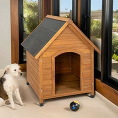 a dog sitting in front of a wooden dog house