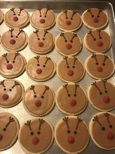 decorated cookies with chocolate frosting and cherries on them are ready to be baked