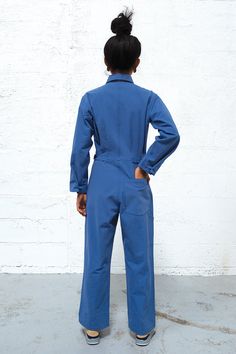 Get ready to enter a bullshit-free zone. This boiler suit is made for movement and comfort, with darts at the back for a feminine touch. Contrast colors at undercollar and sleeve cuff. The style features a wide pant leg and a shorter inseam, so if you’re taller than 5’8”, you get to show off your sexy ankles (or kooky socks or Doc Martens or whatever). 100% cottonMade in China by Uncle Pun Fits true to size. We recommend choosing according to your pant size. If you have a longer torso, please si Cotton Long Sleeve Jumpsuits For Work, Blue Overall Jumpsuit For Work, Fitted Long Sleeve Denim Jumpsuit For Work, Blue Workwear Overalls, Long Sleeve Denim Jumpsuit For Workwear, Fitted Jumpsuits And Rompers With Side Pockets For Work, Relaxed Fit Long Sleeve Denim Jumpsuit For Work, Long Sleeve Overalls With Side Pockets For Work, Long Sleeve Solid Overalls For Work