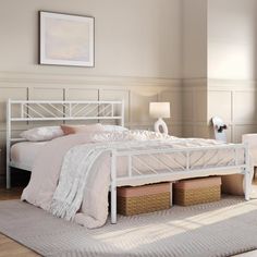 a white bed sitting in a bedroom on top of a hard wood floor