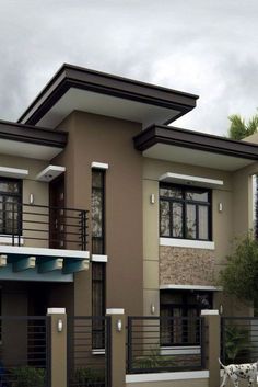 a two story house with balconyes and balconies on the second floor is shown