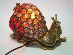 a snail lamp sitting on top of a table