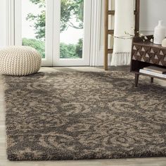 a living room area with a rug and chair