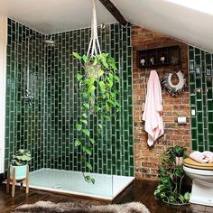 a bathroom with green tile and wooden floors