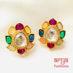 Navratan Kundan Studs with Colored Studs Premium Quality Kundan Studs Length: Approx. 1.25" Width: less than an inch Light-weight Push-Back closure Gold Finish on high-quality brass as the base metal, Kundan stones and beads Suitable for any traditional for contemporary attire and occasion In-stock & ready-to-ship **Color may vary slightly due to photography and lighting. Multicolor Fusion Style Earrings For Ceremonial Occasions, Multicolor Dual-tone Earrings For Festivals, Multicolor Kundan Jhumkas With Cutdana, Heavy Multicolor Earrings For Puja, Multicolor Fusion Jhumkas For Diwali, Fusion Style Multicolor Jhumkas For Diwali, Fusion Style Multicolor Jhumkas For Festivals, Multicolor Jhumkas For Ceremonial Diwali, Multicolor Cutdana Jhumkas For Diwali