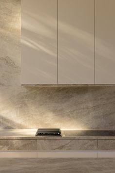 a stove top oven sitting inside of a kitchen next to white cupboards and cabinets