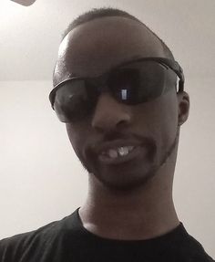 a man with sunglasses on taking a selfie