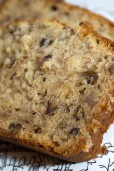 two slices of banana bread sitting on top of a white plate next to each other