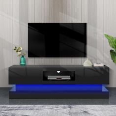 a modern tv stand with a blue light underneath it