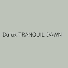 the words dulux tranquill dawn are in black and white on a gray background