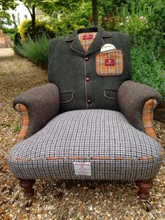 an upholstered chair sitting on top of gravel