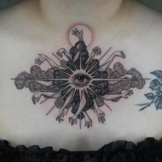 a woman's chest with an all seeing eye tattoo on it