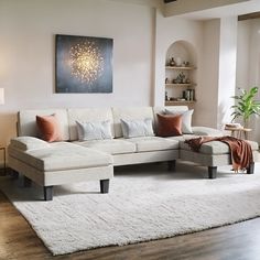 a living room filled with furniture and a large painting hanging on the wall above it