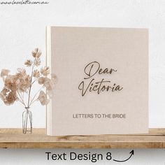 a white book with the words dear victoria letters to the bride next to some flowers