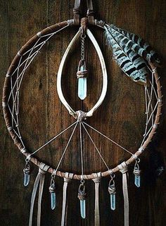 a dream catcher hanging on a wooden wall