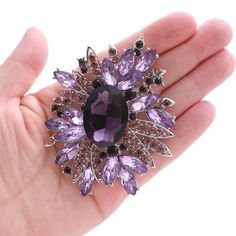 Beautiful large purple brooch rhinestone jewelry, which can be used for your DIY project - purple brooch bouquet, bridal gown sash, ring pillow, cake decorations, event decor, crafts, scrap booking, jewelry gift and much more.  Size: 3 inch high 2 1/4 inches wide Stones color: Regal purple, amethyst and lavender Metal: Silver plated This rhinestone purple brooch can be ordered with pin in the back to wire into brooch bouquet, add to wedding gown or dress sash, or any number of other craft projects or without the pin as a flat back embellishment for your sew-on, glue-on DIY project. More PURPLE brooches - https://www.etsy.com/shop/Crystalitzy?section_id=16136519 Please note that this crystal rhinestone embellishment has flat backing, it is suitable only for your sew-on or glue-on DIY projec Purple Brooch Bouquet, Wizard Robe, Amethyst Brooch, Pillow Cake, Purple Brooch, Lavender Stone, Gemstone Brooch, Brooch Dress, Dress Decoration