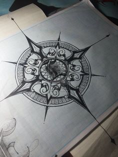 an image of a compass tattoo drawn on paper