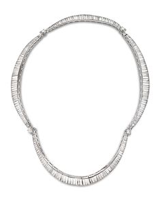 a silver necklace with three rows of beads on the front and back of each strand