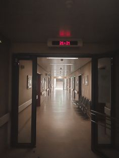 an empty hallway with chairs and signs on the walls