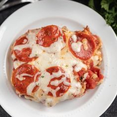 a close up of a plate of food with cheese and pepperoni pizzas on it