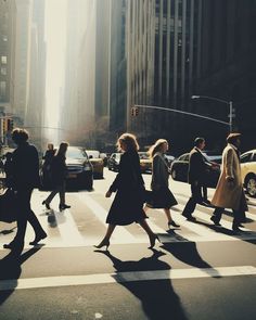 people crossing the street at an intersection in new york city