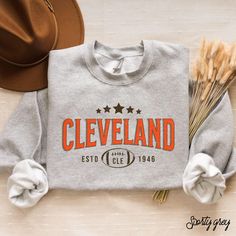 Show your team pride with our vintage Browns football sweatshirt. This unisex crewneck is ideal for game days and tailgating. Stay stylish and comfortable while cheering for the Cleveland Browns! Hey there! 😊👋 Looking for a cozy sweatshirt? You're in the right spot! I'm here to make your shopping experience awesome, so if you have any questions or just want to chat, feel free to reach out anytime. Here's why you'll love these sweatshirts:  ⭐ Cozy & Comfy: 50% cotton, 50% polyester blend (8.0 o Crew Neck T-shirt For Game Day In Fall, Game Day Fan Apparel Sweatshirt In Athletic Heather, Game Day Athletic Heather Crew Neck Sweatshirt, Athletic Heather Sweatshirt For Game Day, Game Day Team Name Sweatshirt In Athletic Heather, Game Day Team Spirit Sweatshirt With Lettering, Team Spirit Sweatshirt With Lettering For Fan Gear, Game Day Fan Apparel Sweatshirt With Lettering, Football Season Team Logo Cotton Sweatshirt