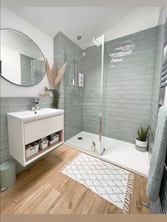 a bathroom with a shower, sink and mirror