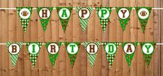 green and white happy birthday bunting banner with football theme on wooden fence background for party decoration