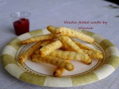 some fried food on a plate next to a drink