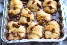 a metal pan filled with pastries on top of a blue and white checkered table cloth