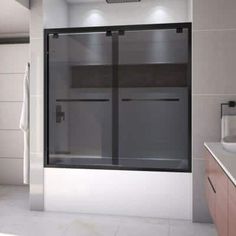 a bathroom with a glass shower door and white tile flooring, along with a sink