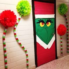 the grinch door decoration is decorated with pom poms