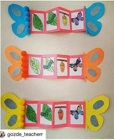 two butterfly themed paper decorations on a table