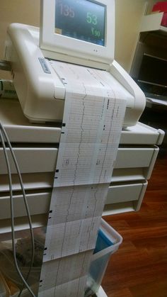 an electronic machine sitting on top of a stack of drawers