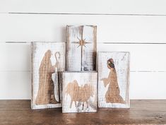 three wooden blocks with nativity images on them