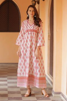 A pretty mix of prints in carnation pink melon and pistachio cover this appealing empire waist maxi dress from Aftab in India. The long flowy cotton dress features three-quarter length sleeves a v-neckline and ties at the side to adjust the fit. Feels like loungewear but looks pretty enough for a garden party! Flowy Cotton Dress, Empire Waist Maxi, Carnation Pink, Cotton Caftan, Empire Waist Maxi Dress, Cotton Maxi Dress, Lounge Dress, Empire Waist Dress, Pink Floral Print