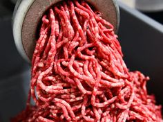 the ground beef is being processed in a machine