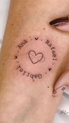 a woman's leg with a tattoo on it that reads and has a heart