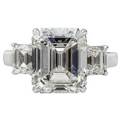 An elegant three-stone engagement ring, showcasing a 6.73 carats emerald cut diamond certified by GIA as J color and VS2 clarity. Flanked by smaller emerald cut diamonds weighing 1.22 carats total. Finely made in a platinum mounting. Size 6 US, resizable upon request. Roman Malakov is a custom house, specializing in creating anything you can imagine. If you would like to receive a special quote on a custom piece, please message or call us. Emerald Cut Diamond Engagement, Emerald Cut Diamond Ring, Emerald Cut Engagement, Platinum Diamond Rings, Emerald Cut Rings, Emerald Diamond Ring, Modern Engagement Rings, Three Stone Diamond, Engagement Ring Diamond Cut