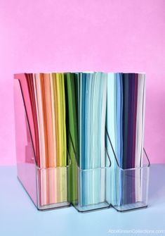 there are many different colored papers in the holder