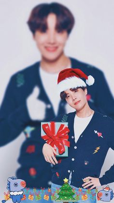 a young man wearing a santa hat and holding a present