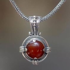 Carnelian pendant necklace, 'Russet Oracle' - Sterling Silver Carnelian Pendant Necklace Round Agate Jewelry For Healing, Red Round Agate Jewelry, Round Carnelian Necklaces With Natural Stones, Elegant Carnelian Round Pendant Jewelry, Red Cabochon Spiritual Jewelry, Spiritual Red Cabochon Jewelry, Amber Amulet Style Round Pendant Jewelry, Amber Amulet Pendant Jewelry, Round Agate Amulet Jewelry