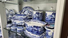 blue and white china is on display in a cabinet