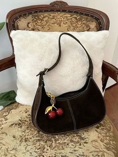 coach cherry charm | brown leather bag | suede | vintage purse | white stitching | vintage coach | purse charm Coach Bag With Cherry Charm, Coach Bags With Charms, Cute Vintage Bags, Cherry Bag Charm, Coach Bag Brown, Coach Cherry Charm, Vintage Purse Aesthetic, Cherry Coach Bag