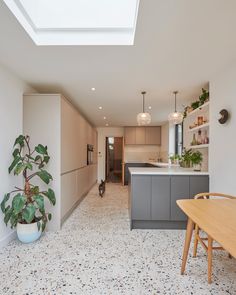 an open kitchen and dining room with skylights