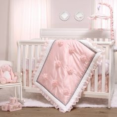 a pink and white baby crib bedding set