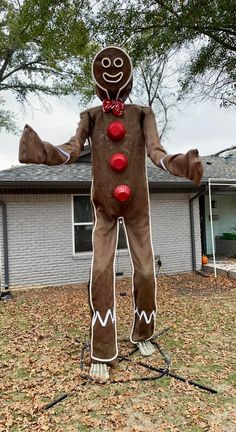 a man in a gingerbread costume standing outside