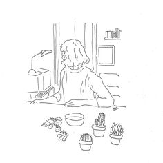 a person sitting at a table with succulents in front of them